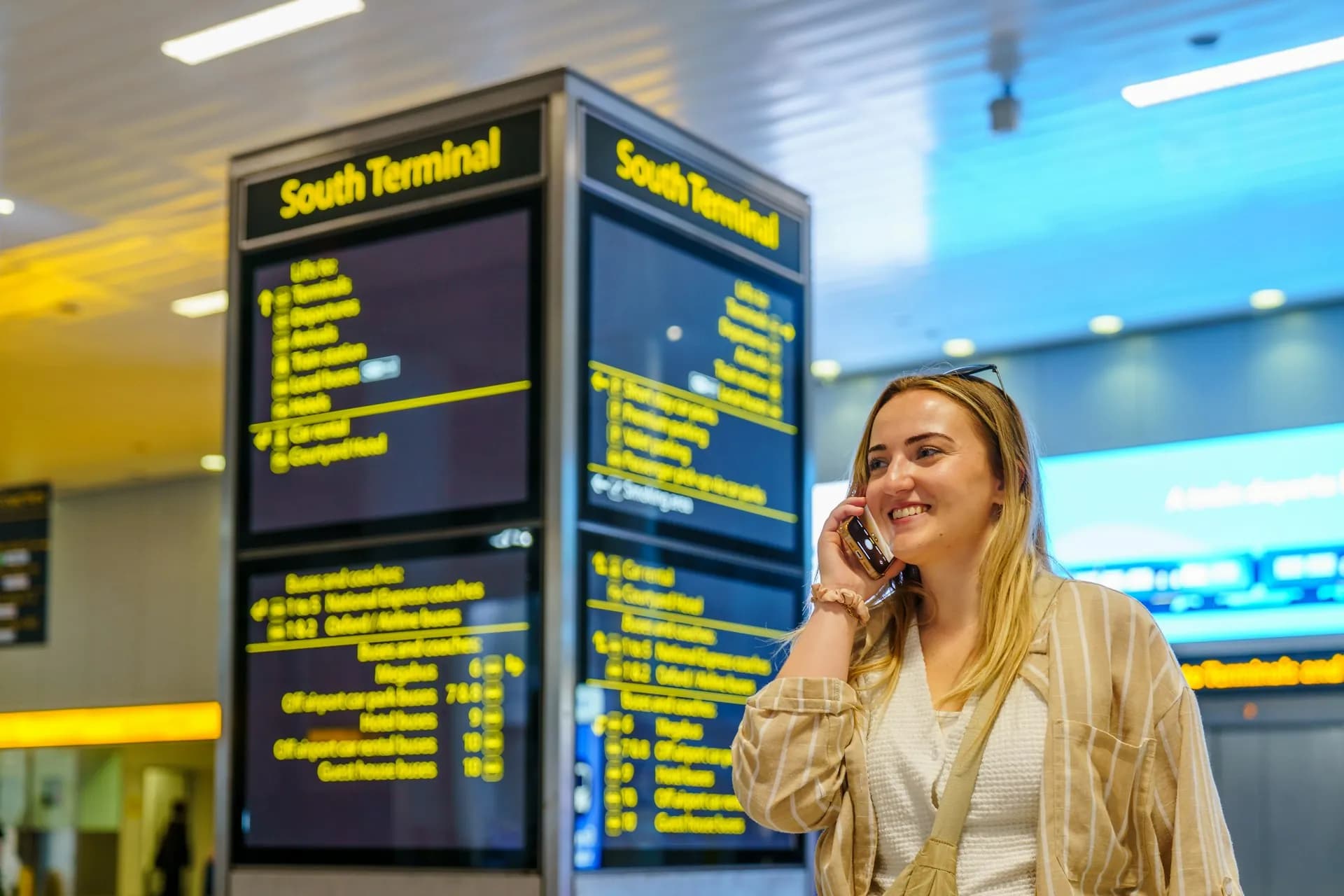 Voyageur utilisant l'application BoardingPlus dans un terminal d'aéroport